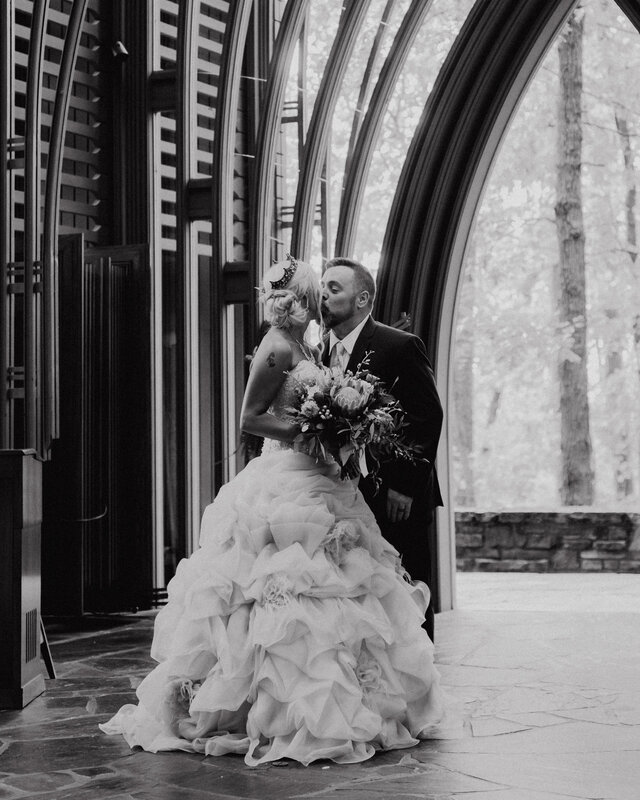Wedding portrait at Cooper Chapel in Bella Vista with soft window light, dark moody tones, and cinematic film-look texture