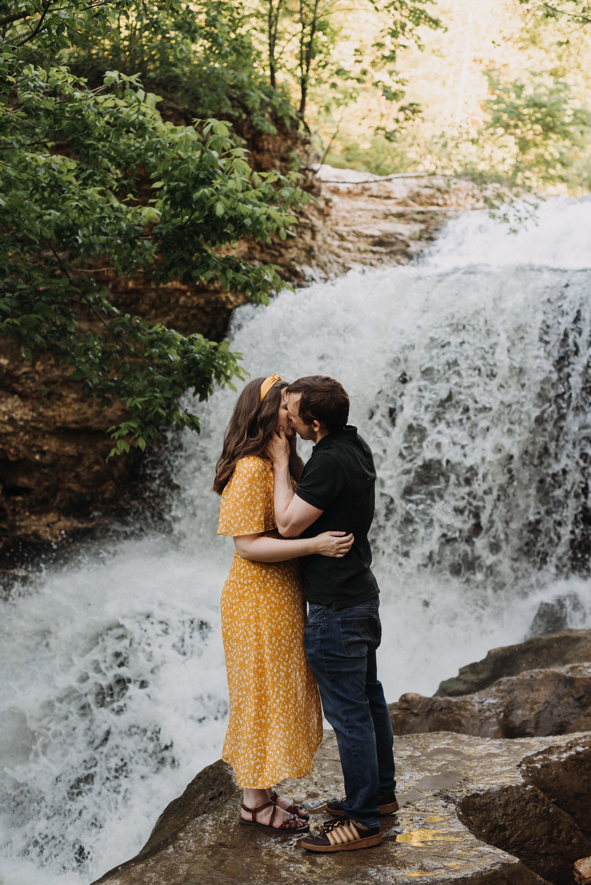 Laurel and Andrew kissing beside the waterfall at Tanyard Creek