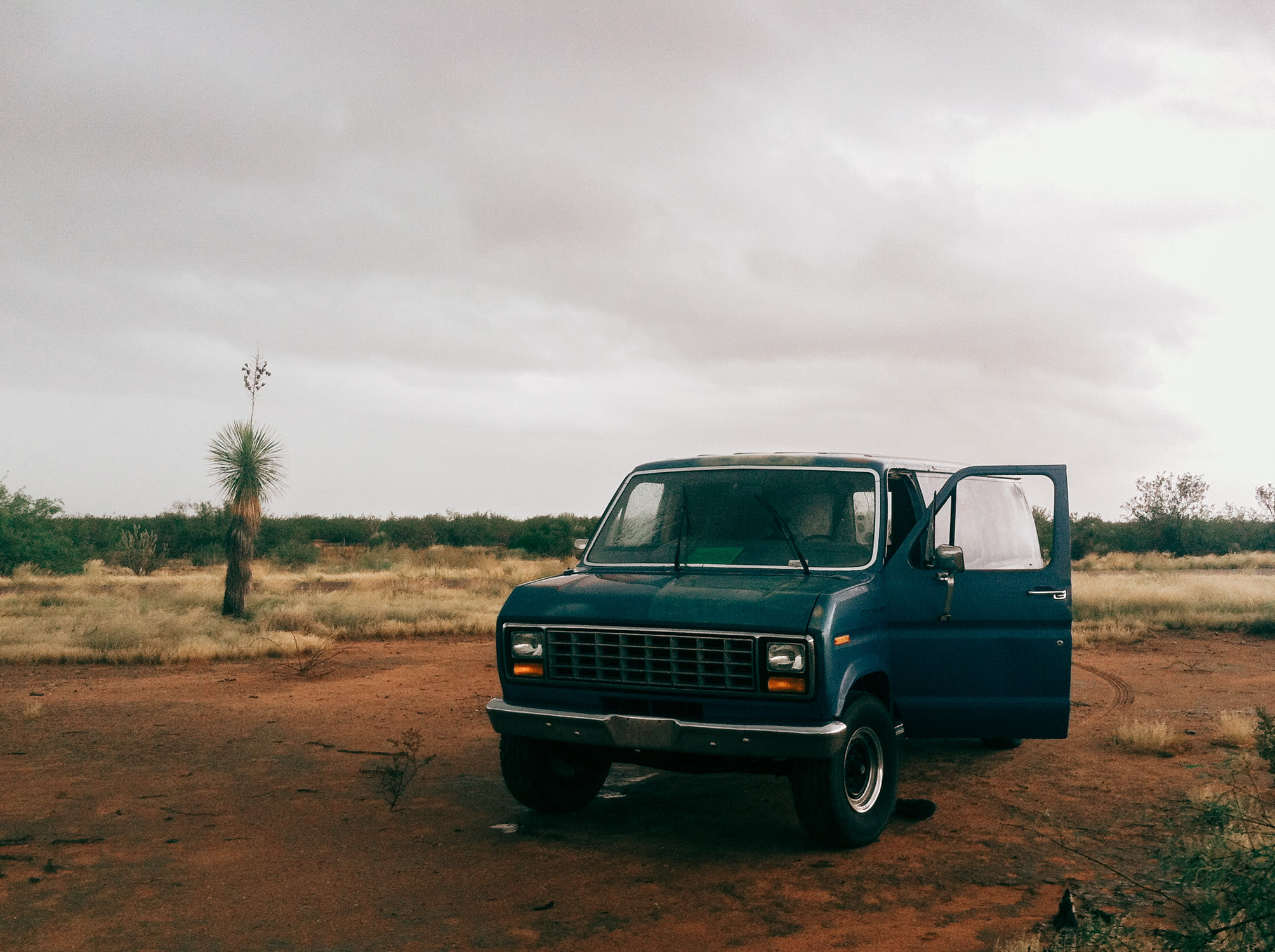 Blue Ford Econoline van on a Kansas roadside from The Nikon Kidd Original Journey hitchhiking and vanlife archive
