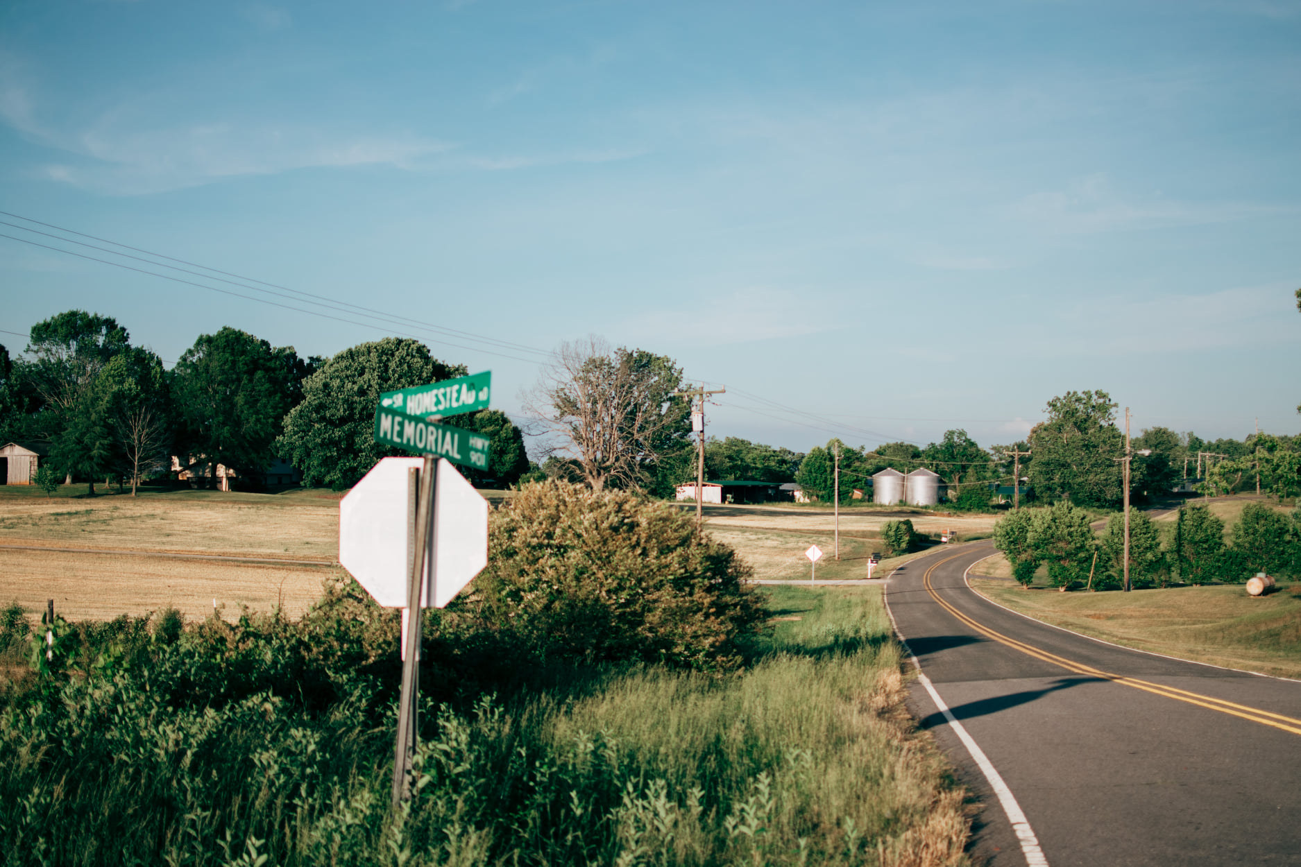 Rural road and sign in the midwest from The Nikon Kidd Original Journey hitchhiking, trainhopping, and vanlife archive.