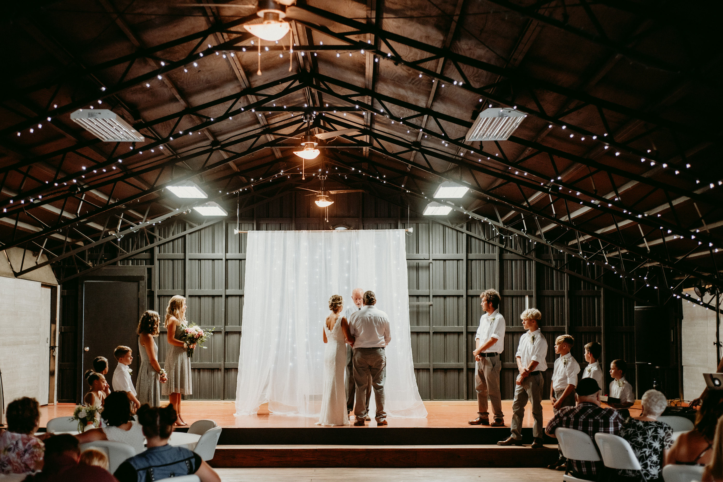 Sarah and Matt intimate Har-Ber Village wedding ceremony in Grove Oklahoma with fairy lights and wedding party