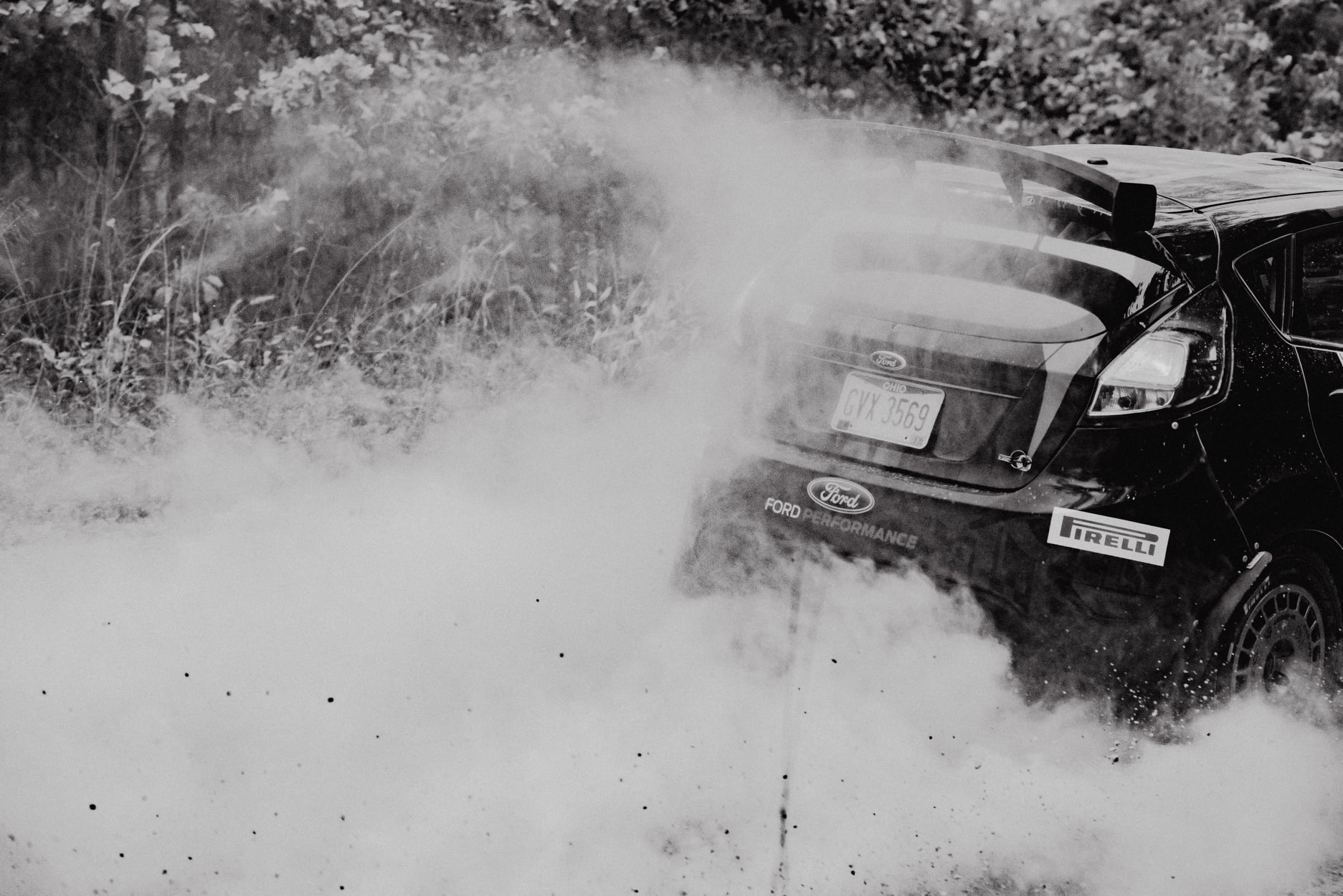 Black and white rally photo of a car cutting through heavy dust at Show Me Rally 2020