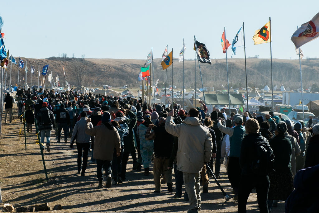 Large flag-lined march through Oceti Sakowin camp during the Dakota Access Pipeline protests