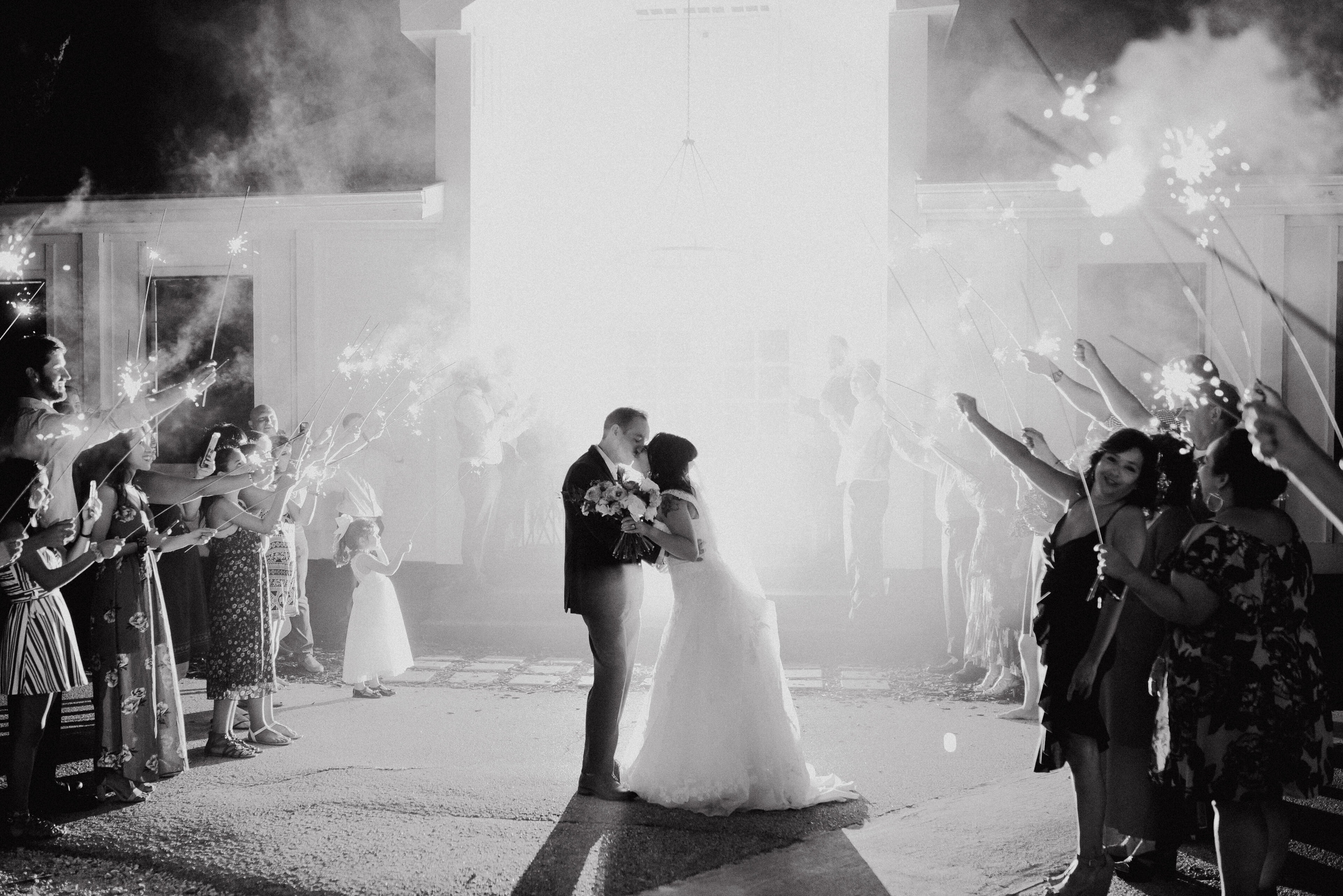 Eraya and Jake sparkler exit with warm lights, nighttime wedding celebration, and cinematic motion